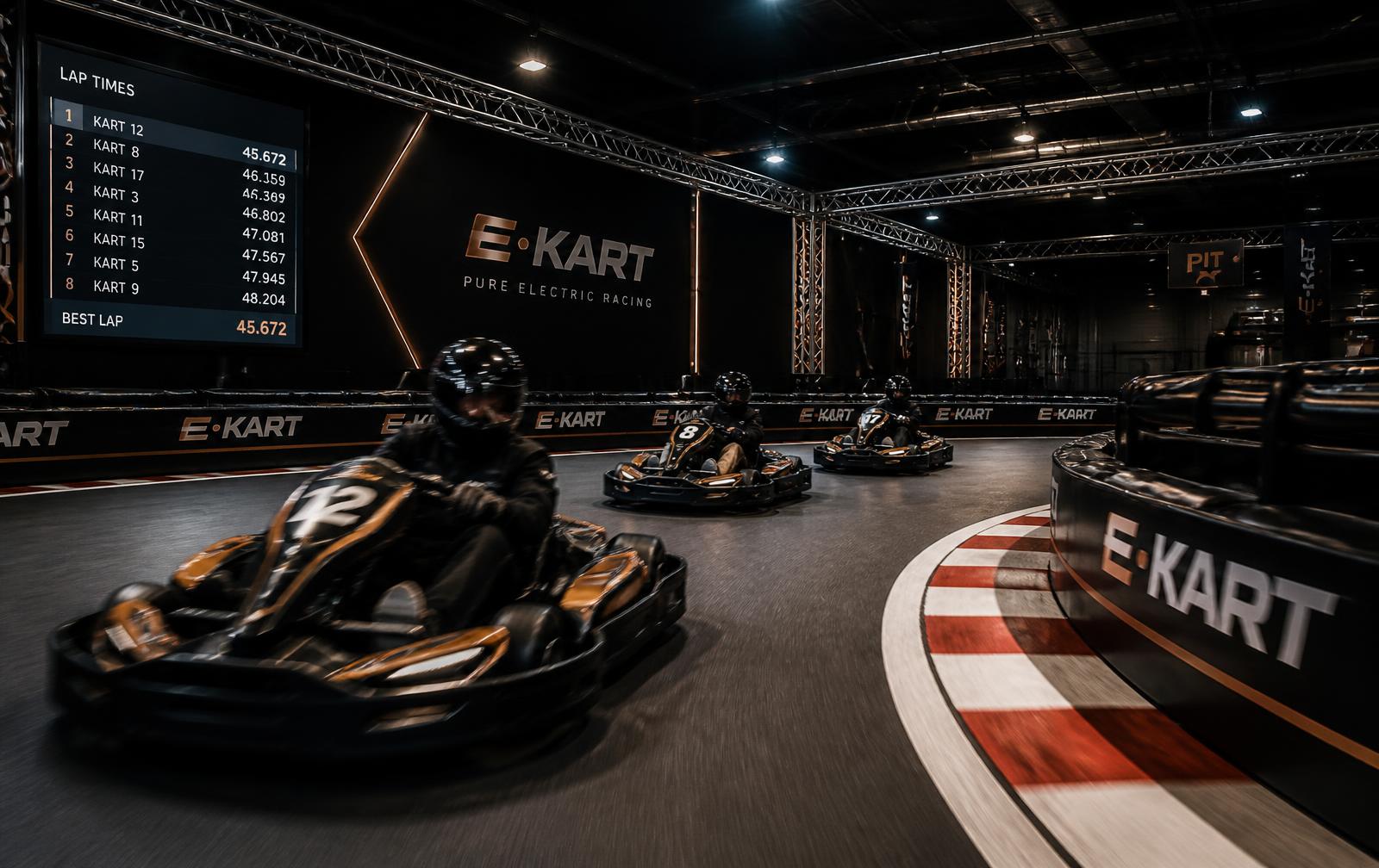 Indoor electric kart circuit with live lap timing screens and branded barriers